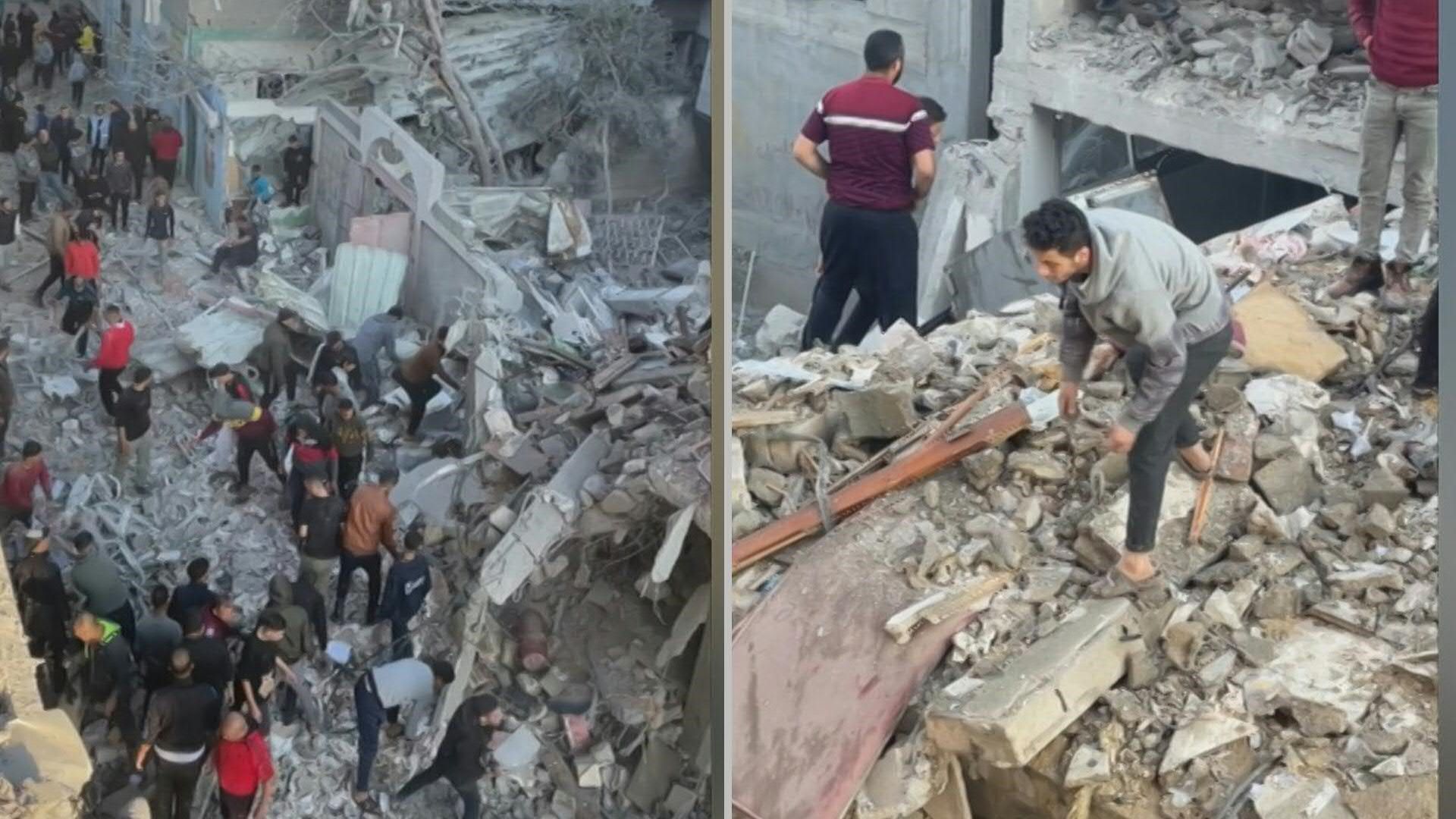 Palestinians inspect the rubble of destroyed buildings in Rafah refugee camp