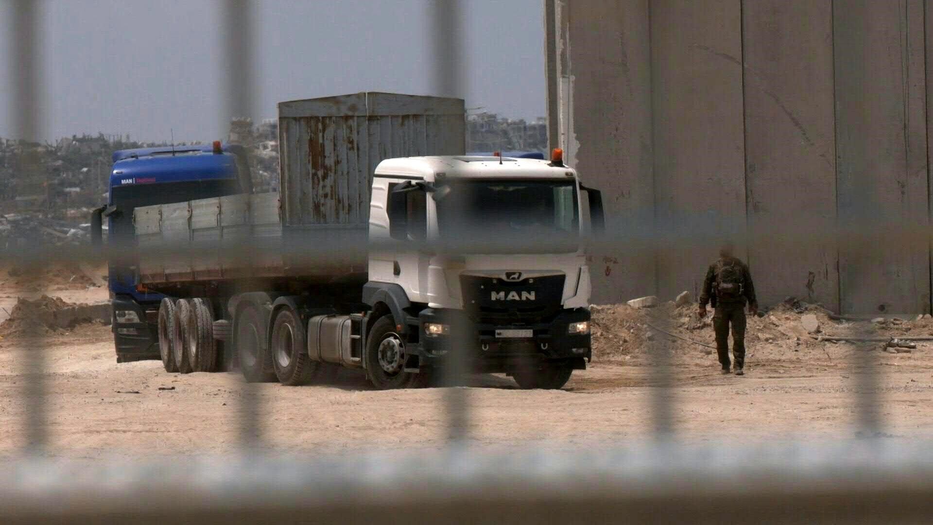 Trucks cross the newly reopened Erez crossing after delivering aid in Gaza