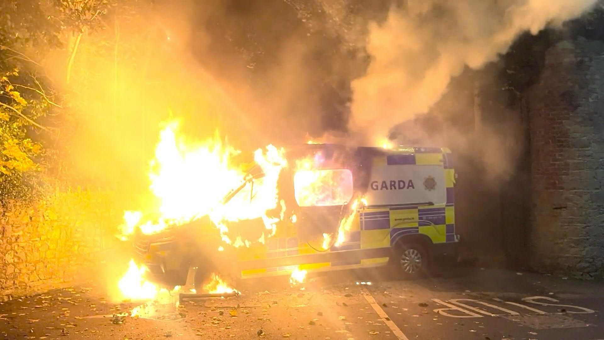 Irish protesters torch police van outside Dublin migrant hotel