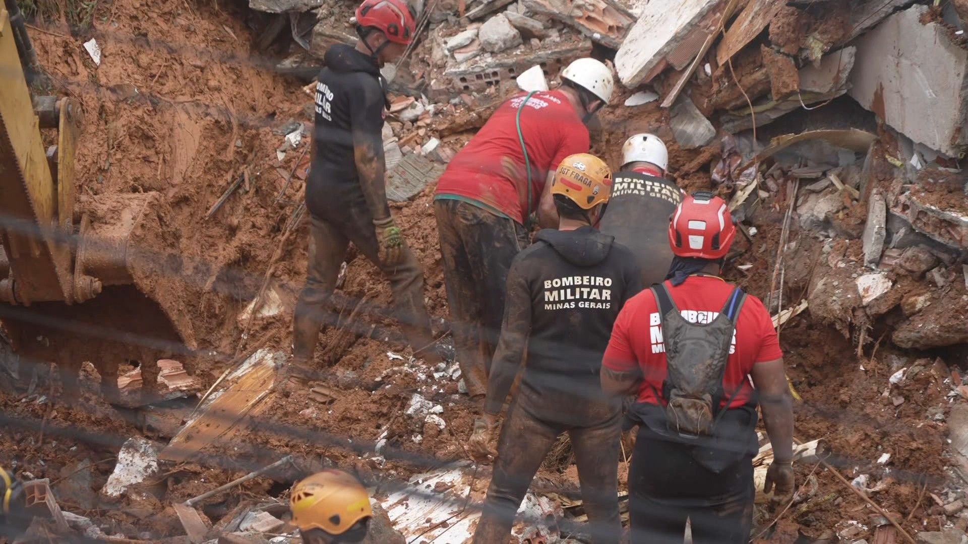 Video: Firefighters recover a body found among debris after a landslide caused by heavy rains