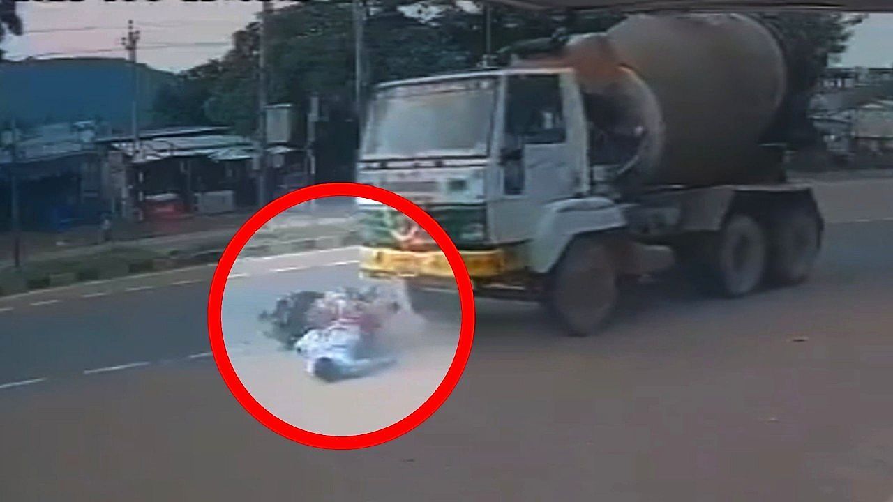 Video: Motorcyclist miraculously survives after slipping under cement mixer truck in India