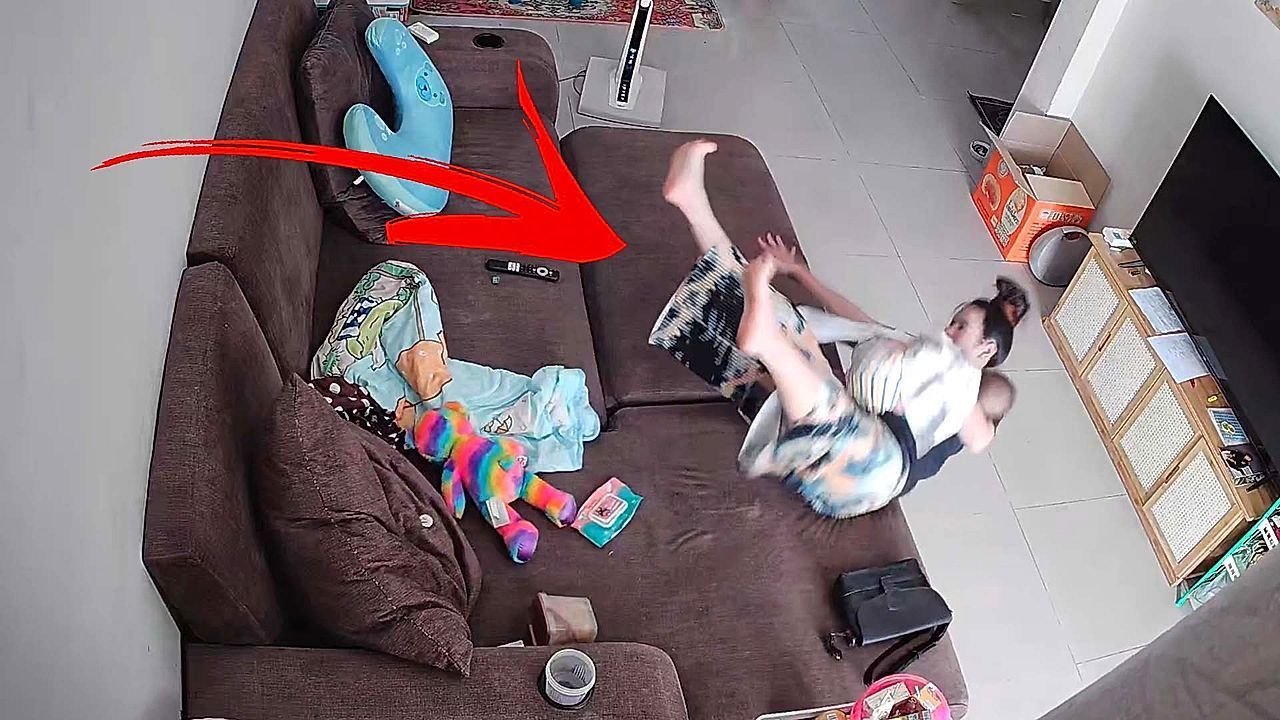 Video: Mother instinct: Woman protects her baby during fall from sofa