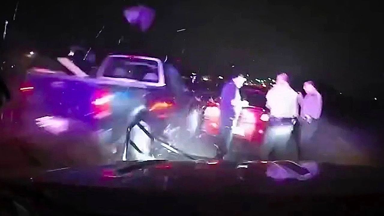 Video: Routine traffic stop turns tense as passing truck clips sheriff's cruiser