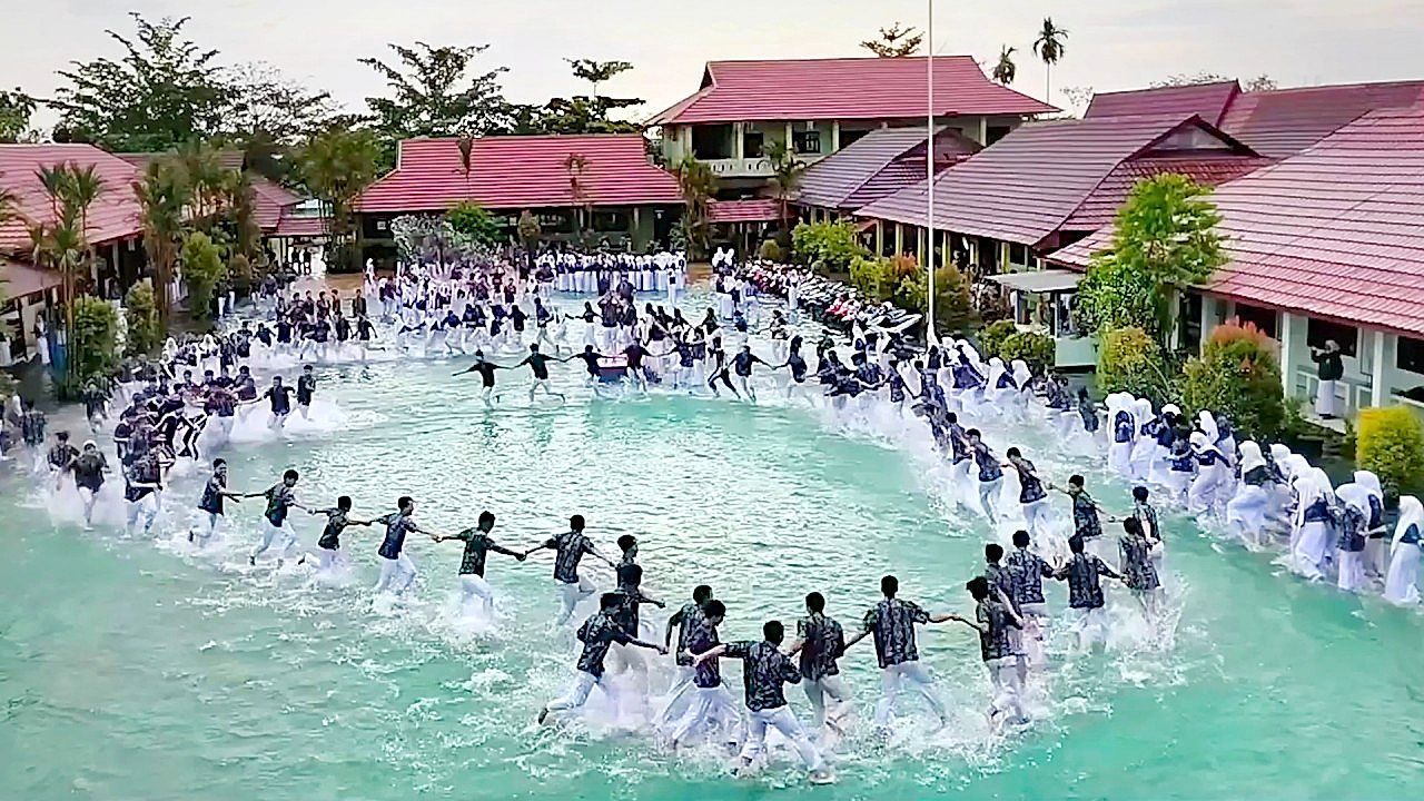 Video: Flooded schoolyard turns into unexpected playground after heavy rain