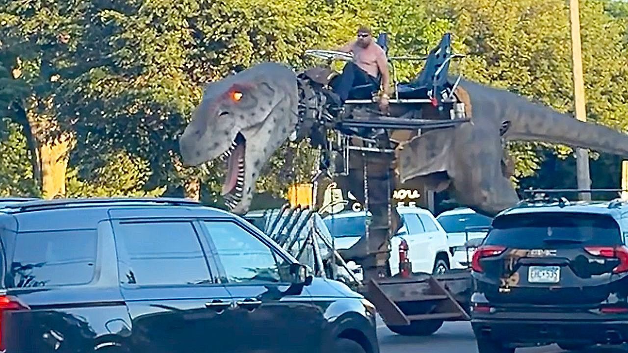 Video: Giant T-Rex vehicle turns heads rolling through streets of Minneapolis