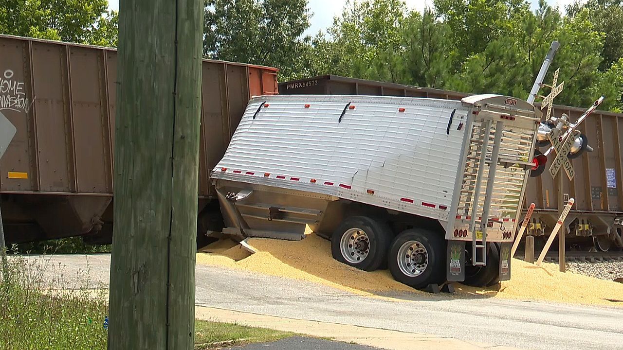 Train splits tractor-trailer in half at railroad crossing in Georgia