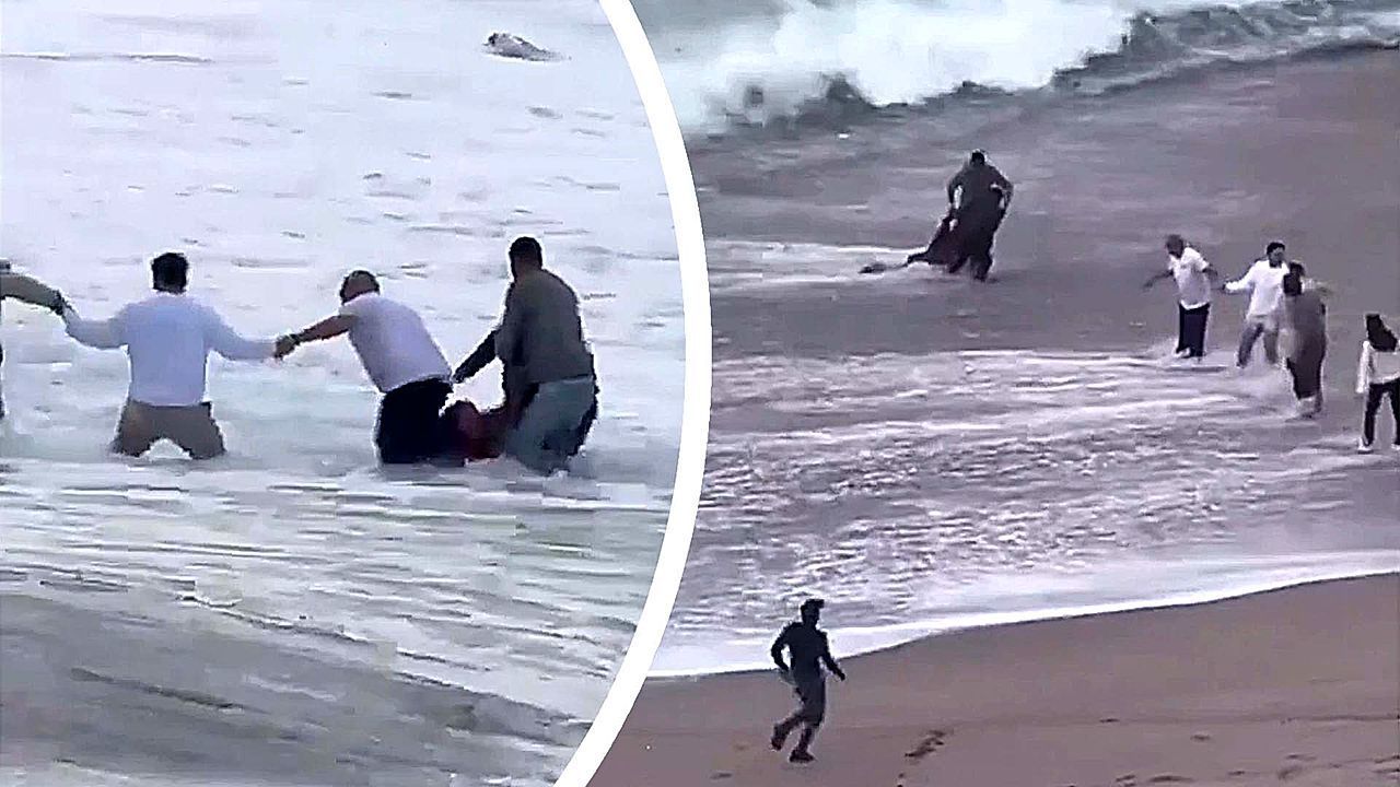 Beachgoers form ten-person human chain to pull woman swept out to sea
